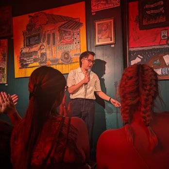 room 808 - a man speaking to a group of people - Comedy Clubs Near Me - Washington, DC, District of Columbia