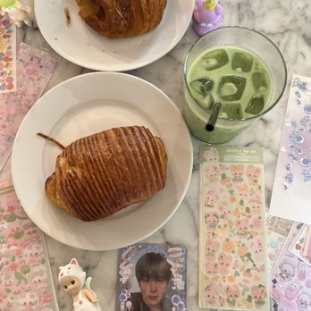 Refuge - Ham & Cheese Croissant (Top); Chocolate Croissant (Bottom); Iced Matcha with Vanilla Syrup - Cocktail Bars Near Me - Houston, Texas Refuge - Ham & Cheese Croissant (Top); Chocolate Croissant (Bottom); Iced Matcha with Vanilla Syrup - Cocktail Bars Near Me - Houston, Texas