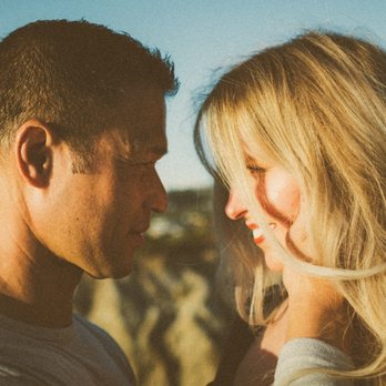 Elyric Films - Engaged couple looks into each other's eyes at San Clemente State Beach - Videographers Near Me