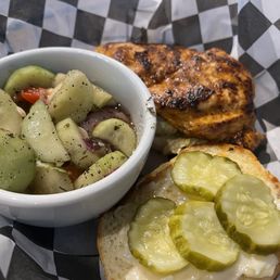 My friend's Nashville hot chicken breast sandwich with cucumbers as her side My friend's Nashville hot chicken breast sandwich with cucumbers as her side