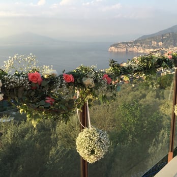 Fiori Sorrento - Mixture of floral runners and baby's breath balls created the backdrop for our ceremony - Wedding Planning Near Me - Sorrento, NA