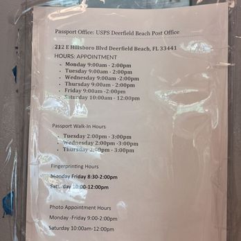 US Post Office - Appointment days & times - A printed schedule of appointment, walk-in, fingerprinting, and photo hours is posted on a glass surface at the USPS Deerfield Beach Post Office. The schedule includes specific days and times for each service, such as appointment hours from Monday to Friday, walk-in hours on Tuesday to Thursday, fingerprinting hours Monday to Saturday, and photo appointment hours Monday to Saturday. - Post Offices Near Me - Deerfield Beach, Florida