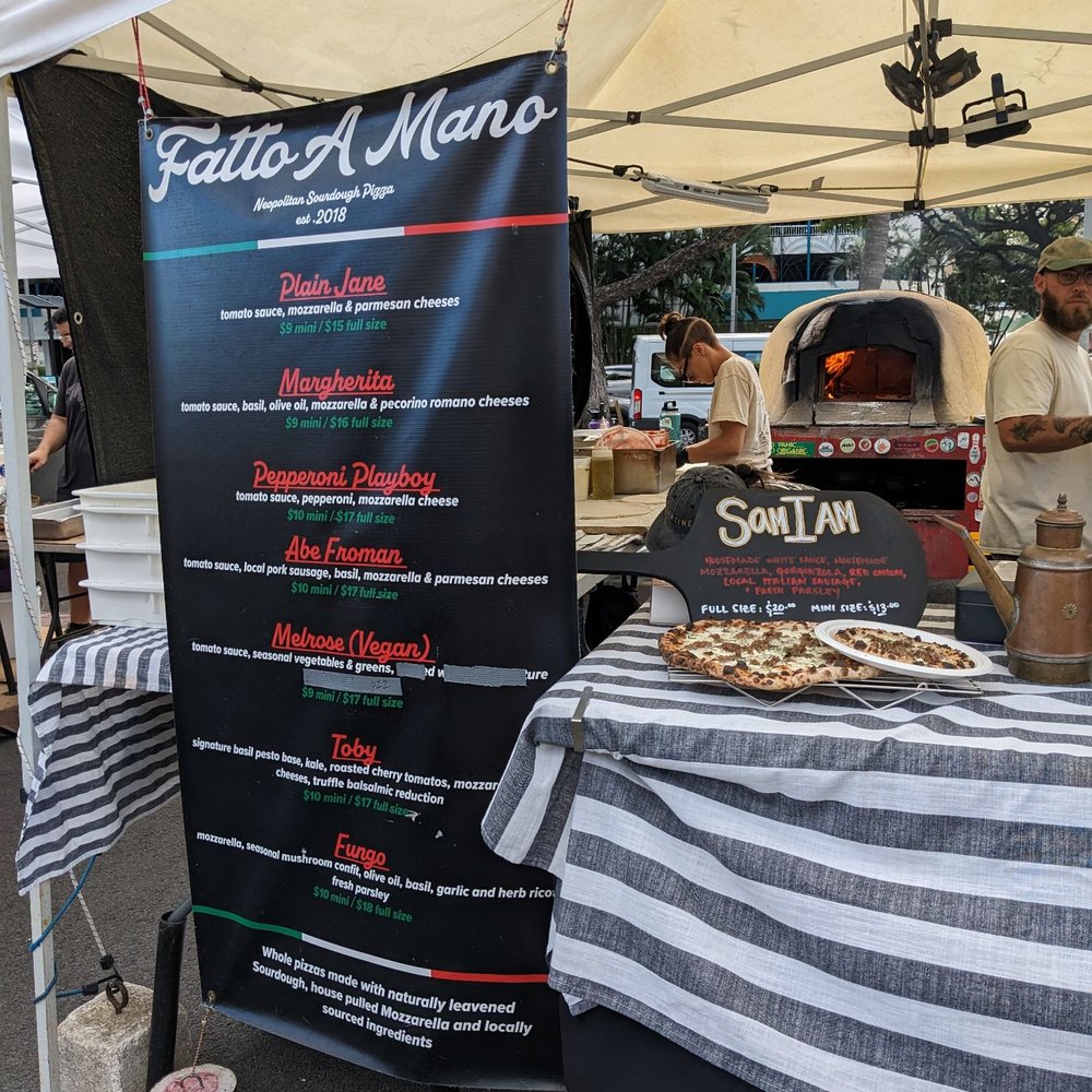 Fatto A Mano - a table with a pizza on it - Pizza Near Me Fatto A Mano - a table with a pizza on it - Pizza Near Me