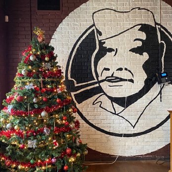 Dreamland BBQ - a christmas tree in front of a mural - Barbeque Near Me - Roswell, Georgia Dreamland BBQ - a christmas tree in front of a mural - Barbeque Near Me - Roswell, Georgia