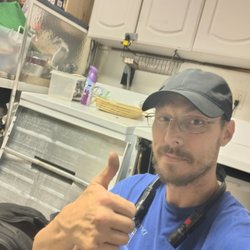 Bargain Appliance Repair and Services - Technician Derek working on a GE washing machine