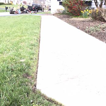 Razor Landscapes - a sidewalk in front of a house - Landscaping Near Me - Lake Shore, Maryland Razor Landscapes - a sidewalk in front of a house - Landscaping Near Me - Lake Shore, Maryland
