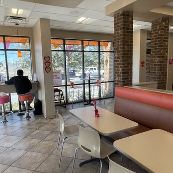 Dunkin' -  a man sitting at a table in a restaurant - Coffee & Tea Near Me - Brooksville, Florida