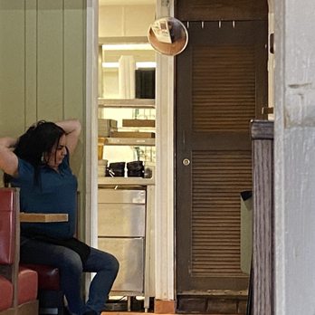 Chili's - a woman sitting at a table in a restaurant - Bars Near Me - Rapid City, South Dakota