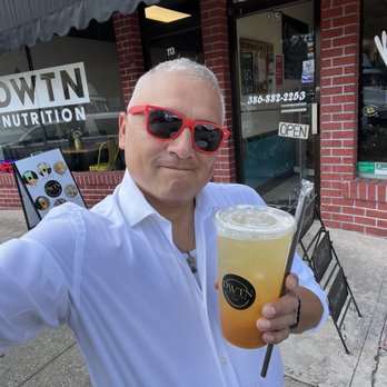 DWTN Nutrition - a man holding a drink - Juice Bars & Smoothies Near Me - DeLand, Florida