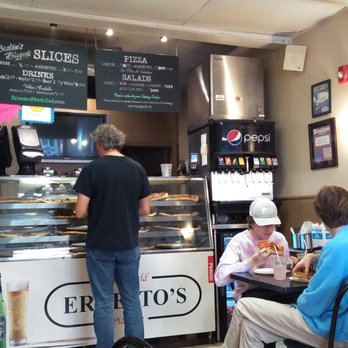Ernesto's - This is the counter, with a drink machine at the right, and some four tops on the right side of the pizzeria. - Pizza Near Me - Boston, Massachusetts Ernesto's - This is the counter, with a drink machine at the right, and some four tops on the right side of the pizzeria. - Pizza Near Me - Boston, Massachusetts