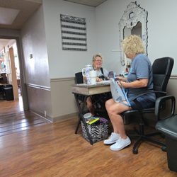 MarShels Hair and Nail Studio - A nail technician finishing up a service.