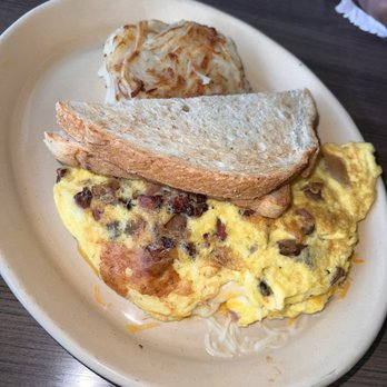 Snooze, an A.M. Eatery - 3 Egg Omelette- Cheddar Jack Cheese Blend with Bacon, Hashbrowns, Sourdough Bread - Breakfast & Brunch Near Me - Houston, Texas