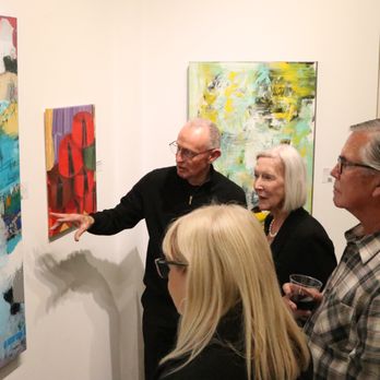 OCFA Showcase Gallery - Artist Bob Hogue discussing his work with visitors to the gallery. - Art Galleries Near Me - Santa Ana, California OCFA Showcase Gallery - Artist Bob Hogue discussing his work with visitors to the gallery. - Art Galleries Near Me - Santa Ana, California