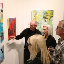 OCFA Showcase Gallery - Artist Bob Hogue discussing his work with visitors to the gallery.