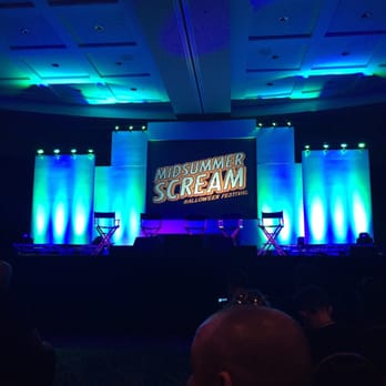 Midsummer Scream - Waiting for the Dark Harbor panel. Sitting on the aisle so I can seen. Unfortunately this also makes me a target of "scarers". Oh, well! - Festivals Near Me - Long Beach, California