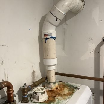 Eco-friendly Plumbing - A couple of years of condensate, from improperly glued venting pipes, that pooled on top of the tankless water heater. - Plumbing Near Me - Granada Hills, California