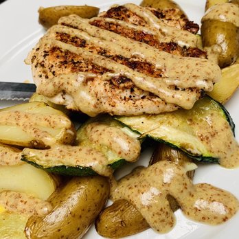 Eli's Table - Grilled chicken with fingerling potatoes, seasonal veggie medley, and a mustard vinaigrette. - Southern Near Me - Charleston, South Carolina