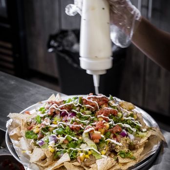 Guac Mexi Grill - Brooklin - nachos being prepared - Mexican Near Me - Whitby, Ontario Guac Mexi Grill - Brooklin - nachos being prepared - Mexican Near Me - Whitby, Ontario