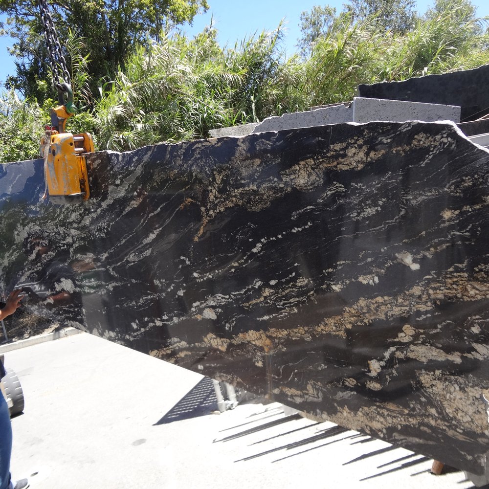 Innovative Tile Concepts - a man standing next to a large slab of granite - Flooring Near Me - Campbell, California Innovative Tile Concepts - a man standing next to a large slab of granite - Flooring Near Me - Campbell, California
