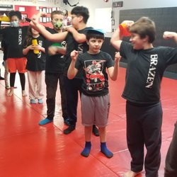 Brazen Martial Arts - Kids 8-13 flexing after finishing class.