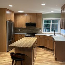 Maple cabinets with honey finish; Arizona Tile New Taj quartz countertop.