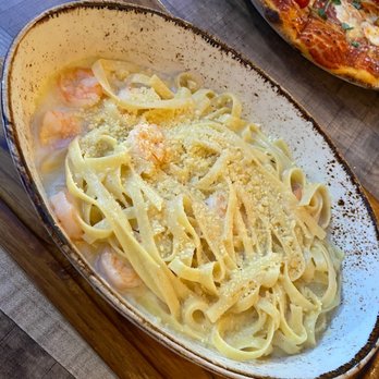 Fiorella's Italian Kitchen - a plate of pasta and a pizza - Pizza Near Me - Oxon Hill, Maryland
