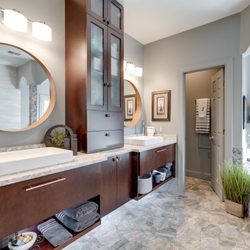 Reico Kitchen & Bath - Modern slab door with warm cherry finish in the master bathroom.