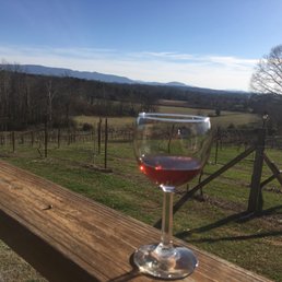 a glass of wine on a wooden deck