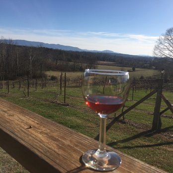 Blue Goose Vineyards - a glass of wine on a wooden deck - Wineries Near Me - Maryville, Tennessee