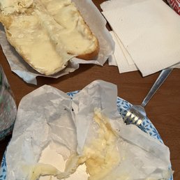 Cheese bread lost in its battle with the wax paper! Cheese bread lost in its battle with the wax paper!