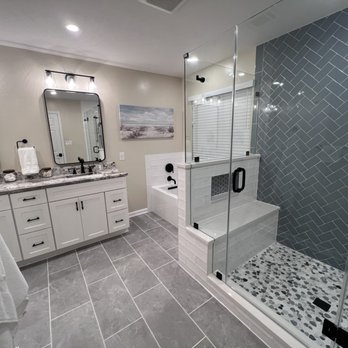 Looney's Tile & Grout Restoration - a bathroom with a walk in shower - General Contractors Near Me - Ashburn, Virginia Looney's Tile & Grout Restoration - a bathroom with a walk in shower - General Contractors Near Me - Ashburn, Virginia