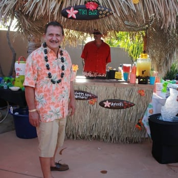 Tikiland - Tiki hut bar coverlet and grass table wrap, and my dad, The Birthday Boy  :D - Party & Event Planning Near Me - San Diego, California
