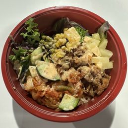Half rice and salad with spicy beef and toppings.
