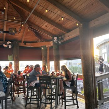 Boshamps Oyster House - Outdoor bar - seating at hi-top tables or bar, dog-friendly area - perfectly located to snap a sunset photo - Cajun/Creole Near Me - Destin, Florida