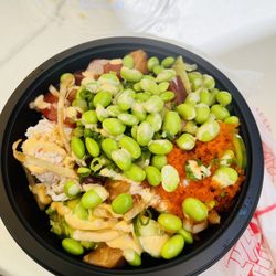 Salmon and tuna poke bowl with brown rice, edamame, masago, crab and spicy Mayo