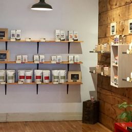 a coffee shop with shelves of coffee