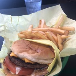 Delicious cheeseburger with grilled onions and fries.