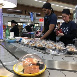 Rolling sushi bar on conveyor belt Rolling sushi bar on conveyor belt