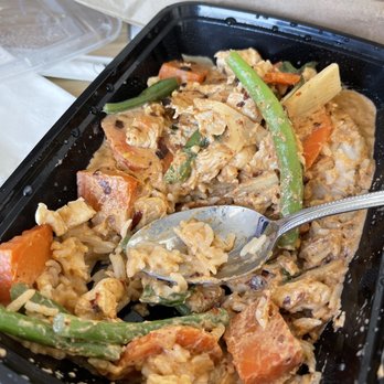 Take It Easy - a tray of food with a spoon in it - Thai Near Me - Oakland, California