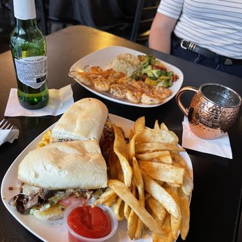 The Block - Front - "The Jon" sandwich with chicken and fries Back - shrimp skewers with rice and veggies - Apartments Near Me - Indianapolis, Indiana
