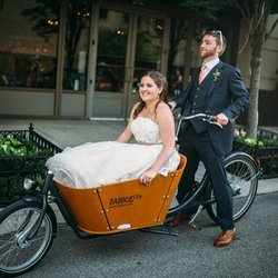Firth & Wilson Transport Cycles - Groom sweeps his bride off her feet in a Babboe City Dutch cargo bike.