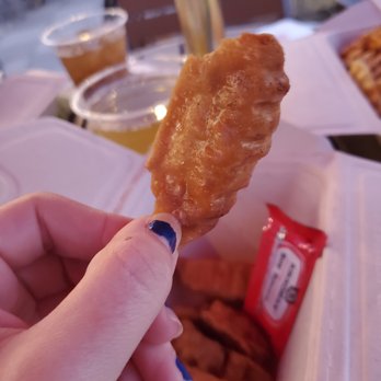 Yoshi's Kitchen - a hand holding a piece of fried food - Food Trucks Near Me - Savannah, Georgia Yoshi's Kitchen - a hand holding a piece of fried food - Food Trucks Near Me - Savannah, Georgia