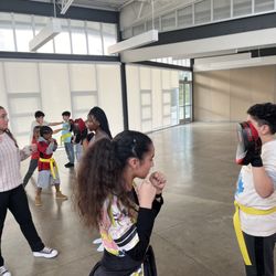 Just Kickin’ It kickboxing - Newly Promoted Yellow Belts going over punch drills