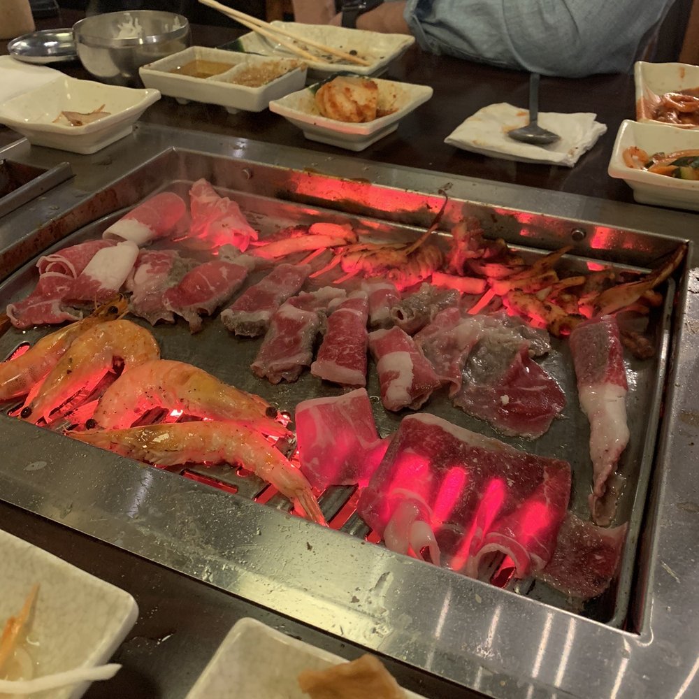 Surah - a man sitting at a table with food on it - Japanese Near Me - Spring House, Pennsylvania
