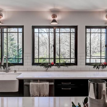 Clarksville Construction Services - a kitchen with black cabinets and white countertops - General Contractors Near Me - Bishopville, Maryland Clarksville Construction Services - a kitchen with black cabinets and white countertops - General Contractors Near Me - Bishopville, Maryland
