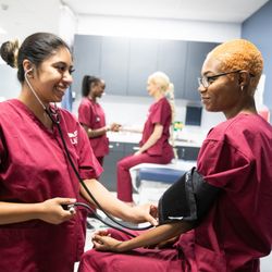 UEI College - Reseda - Medical Assistant students performing tasks on each other.