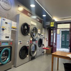 Lavandaria Self-Service Cheir'a Lisboa - Drying section.  Fees table left upper side.