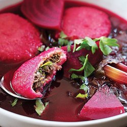 Kubeh - Kurdish slow cooked beef Kubeh served in beet broth with celery and herbs.