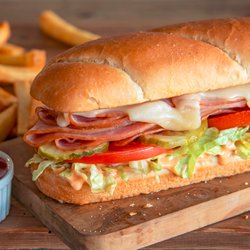Shoney's - Grilled smokehouse ham served on a toasted hoagie with melted Swiss cheese, tomatoes, lettuce, pickles, and our signature Sho...