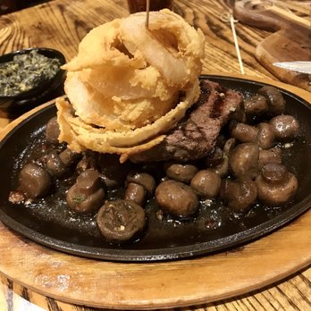 Harrigan’s - 8oz sirloin stockyard style on a bed of sizzling sautéed mushrooms and onion rings. - Steakhouses Near Me - Lubbock, Texas
